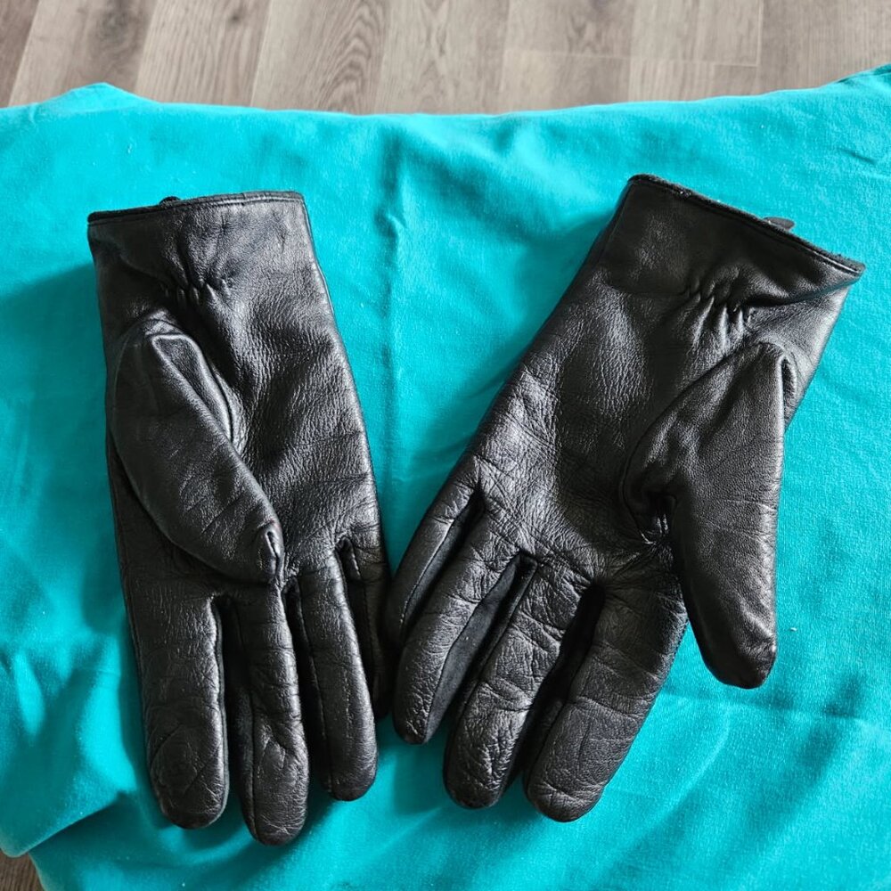 Black leather gloves with warm lining accented with gold buttons